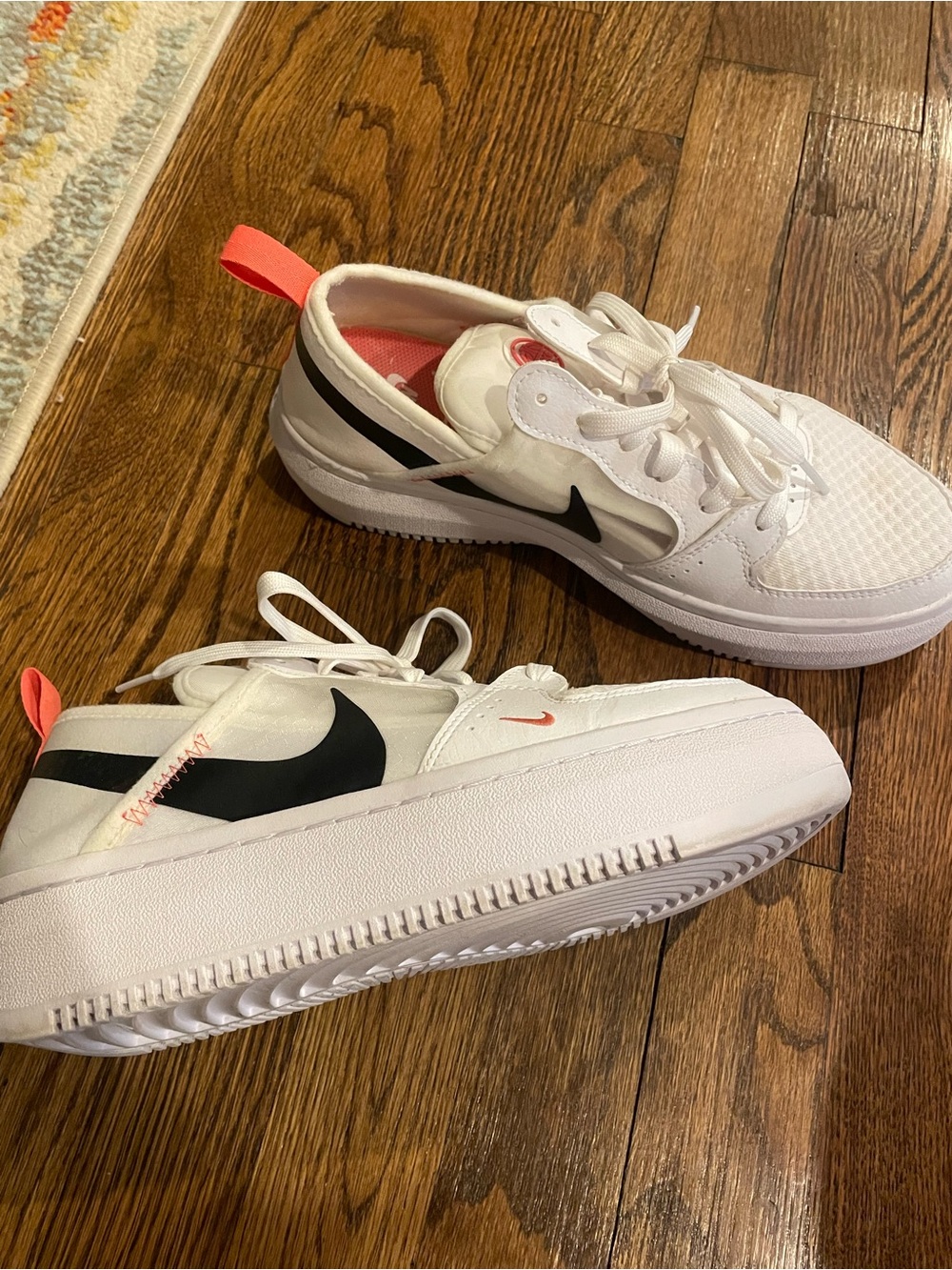 Nike Women’s White Sneakers with Black Nike sign and Coral Pink Pull Tab